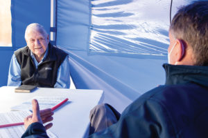 BVC chaplain and resident talking in open air tent during pandemic
