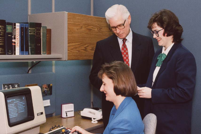 Foundation staff Celinda Olszewski (seated), Shryln Treadwell and C. Duane Riley crunch numbers using the organization’s first computer system (c. 1986).
